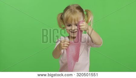Child Having Fun Making Ping Slime. Kid Playing With Hand Made Toy Slime. Funny Kid Girl. Relax And 