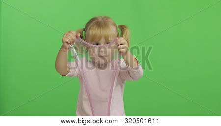 Child Having Fun Making Ping Slime. Kid Playing With Hand Made Toy Slime. Funny Kid Girl. Relax And 