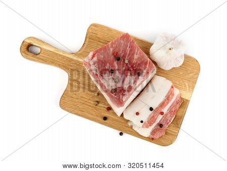 Board With Cut Pork Fatback, Pepper And Garlic Isolated On White, Top View