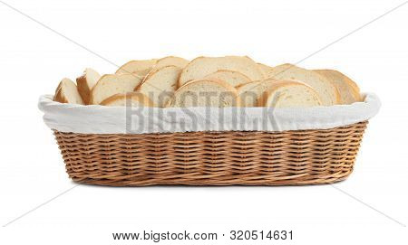 Slices Of Tasty Fresh Bread In Wicker Basket On White Background