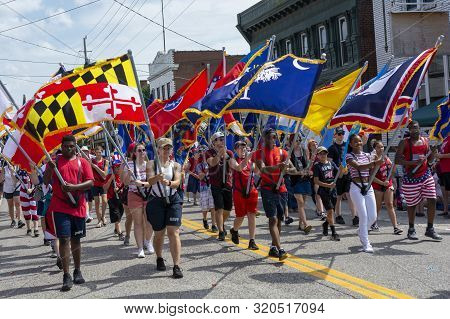 Saint Charles, Missouri 7-4-2019 -usa, Independence Day Parade, Children And Teens Carrying Flags Fr
