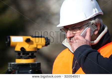 Civil engineer with surveying equipment