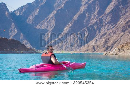 Young Man Kayaking In Hatta Dam Beautiful Place For Water Adventure Activities Like Boat Safari Kaya