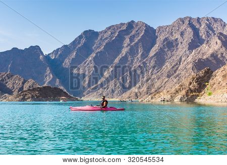 Best Water Sports Adventure Activities In Dubai, Young Man Kayaking In Hatta Dam Famous Tourist Attr