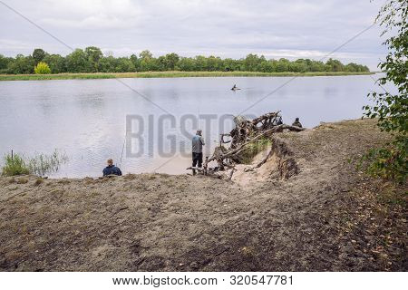 City Carnikava, Latvian Republic. Fisherman Catching Fish In The River, Nature, Silence And Water Wa