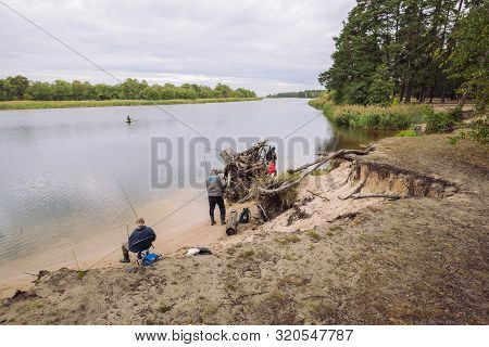 City Carnikava, Latvian Republic. Fisherman Catching Fish In The River, Nature, Silence And Water Wa