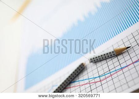 Broken Pencil Lies On Table Against Background Of Business Charts. Improper Business Concept