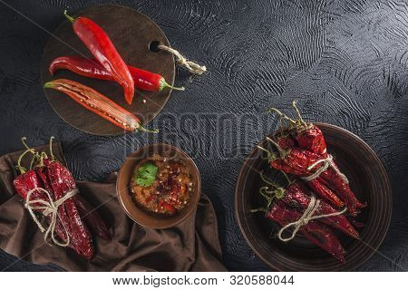 Spicy Chili On A Dark Background In Ceramic Plates, Flatlay. Used As An Ingredient For Harissa, Ajik