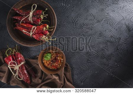 Spicy Chili On A Dark Background In Ceramic Plates, Flatlay. Used As An Ingredient For Harissa, Ajik