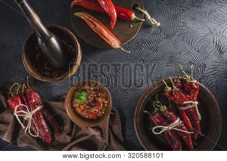 Spicy Chili On A Dark Background In Ceramic Plates, Flatlay. Used As An Ingredient For Harissa, Ajik