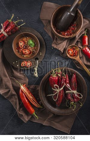 Spicy Chili On A Dark Background In Ceramic Plates, Flatlay. Used As An Ingredient For Harissa, Ajik