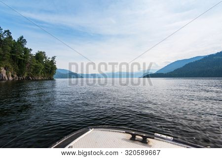 Teletskoye lake in Altai mountains, Siberia, Russia. Beauty summer morning. The lake is a UNESCO World Cultural and Natural Heritage Site. View from boat