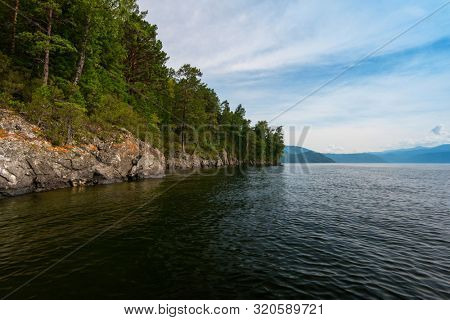 Teletskoye lake in Altai mountains, Siberia, Russia. Beauty summer morning. The lake is a UNESCO World Cultural and Natural Heritage Site.