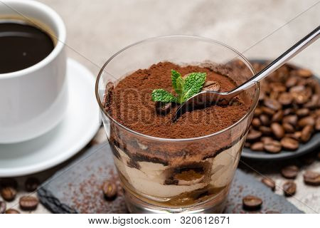 Portion Of Classic Tiramisu Dessert In A Glass Cup On Stone Serving Board And Fres Espresso Coffee O