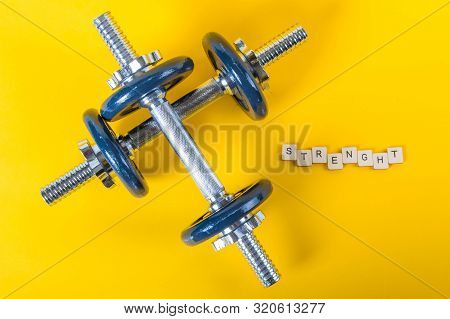 Healthcare Concept Showing Dumbbells And The Message Strength