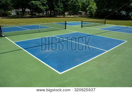 Recreational Sport Of Pickleball Court In Michigan, Usa Looking At An Empty Blue And Green New Court