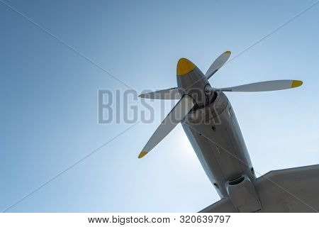 Airplane Propeller Of Military Aircraft, Copy Space. Blue Sky Background.