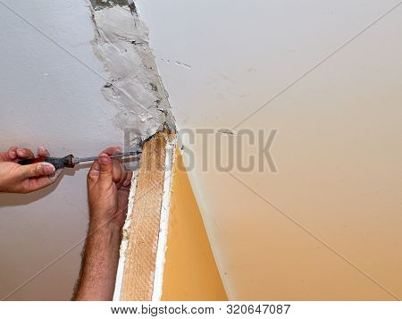 Man Repairing A Wall
