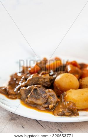 Beef meat stewed with potatoes-Traditional French cuisine Beef Bourguignon potatoes carrots in persillade