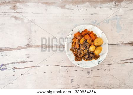 Beef meat stewed with potatoes-Traditional French cuisine Beef Bourguignon potatoes carrots in persillade