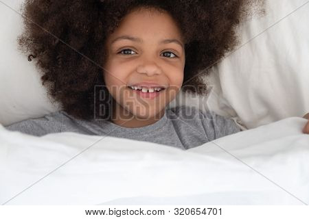 Happy African American Kid Girl Waking Up In The Morning.