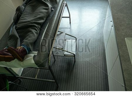 View From Above Of Woman On Doctors Ward - Covered With Blanket Waiting For The Doctor To Come
