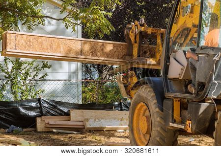 A Construction Worker Installing Silent Floor Forklift Stacker Loader Joists In New Construction