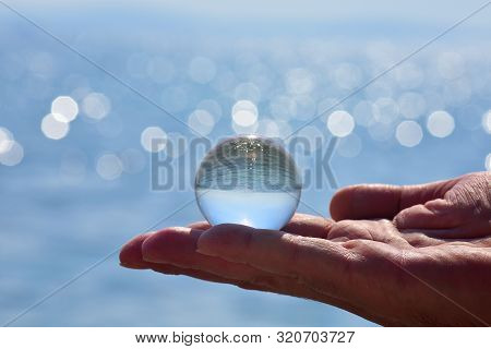 Beautiful Summer Coast Seen Through A Blue Glass Ball/ Blue Freedom Concept/ Ocean Surface Ripples A