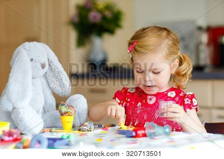 Adorable Cute Little Toddler Girl With Colorful Clay. Healthy Baby Playing And Creating Toys From Pl