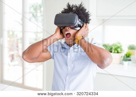African amaerican man having fun playing with virtual reality glasses