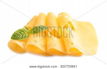 Slices Of Tasty Maasdam Cheese With Basil On White Background