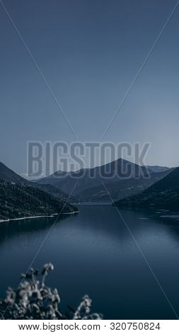 Zhinvali Reservoir Lake Landscape With Mountains . The Main Caucasus Ridge.