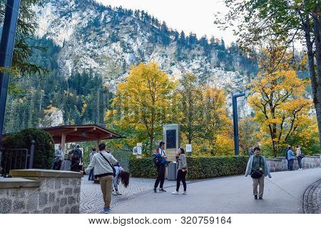 Schwangau, Germany - Oktober 09, 2018: Tourists Walk In The Park In The Alps In Autumn