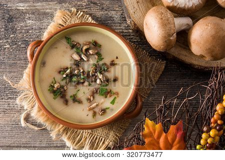 Homemade Mushroom Soup In Bowl On Wooden Table. Top View.