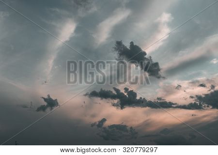 Evening Sky At Sunset Background. Dark Clouds Hanging Above Horizon. Majestic Cloudscape In Blue, Or