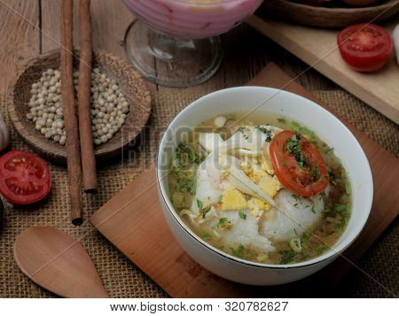 Food Photography, Bubur Ayam Or Indonesian Chicken Porridge Served With Chicken Broth Soup And Tomat
