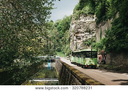 Luxembourg City,luxembourg - May 19, 2019: Citytrain Going Past Petrusse River In A Park In Luxembou