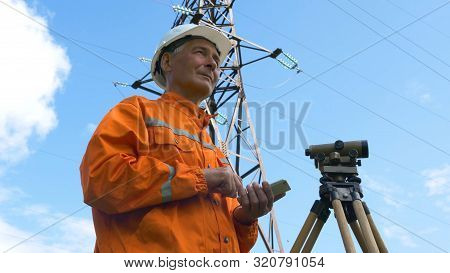 Senior Explorer Types On Modern Phone At Geodetic Device