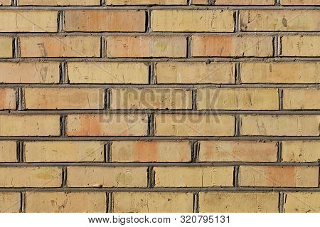 The Old Brick Wall Have An Orange Color And A Weathered Texture With Cement Jointing.
