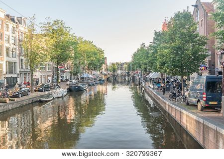 Amsterdam, Netherlands - June 6, 2019: Canal In Amsterdam City Center At Sunny Day.