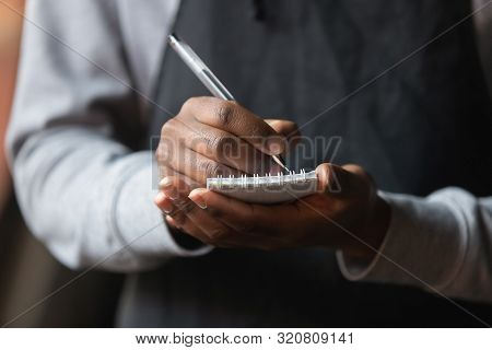 Close Up African American Waiter Hands With Notebook, Taking Customer Order