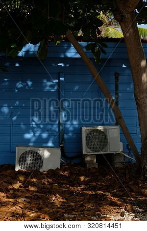 Old Air Conditioning Units Behind A House In Bonaire
