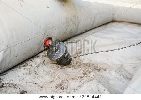Inflate A Rubber Boat. Repair The Pump In The Boat. Man Thinks Up A Boat. Preparation For Fishing.