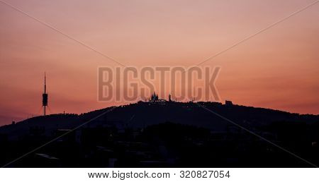 Tibidabo Mountain Silhouette, With The Church And Communications Antenna Of Collserola. Sunset In Th