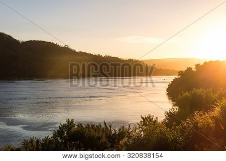 Sunset At The Mouth Of The Valdivia River, Near The City Of The Same Name, In The Region Of The Rive