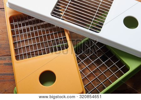 Pile Of Vegetable Slicers On Wooden Background