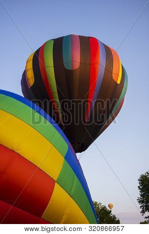 Festival Goers Watch Hot Air Balloons Take To Flight Early Saturday Morning On A Cloudless Sky At Th