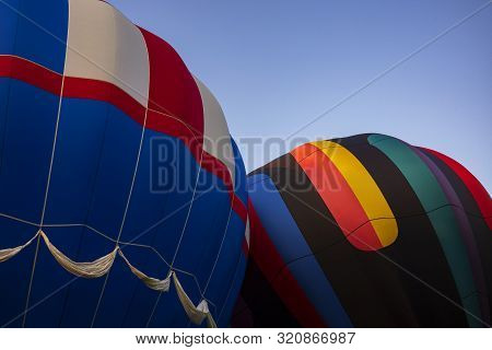 Festival Goers Watch Hot Air Balloons Take To Flight Early Saturday Morning On A Cloudless Sky At Th