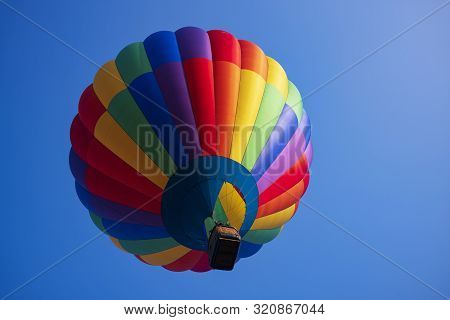 Festival Goers Watch Hot Air Balloons Take To Flight Early Saturday Morning On A Cloudless Sky At Th