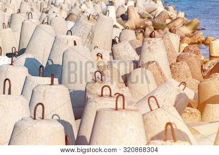 Breakwaters In Sea. Beautiful Sunset Seascape With Concrete Tetrapodes For Protect Coastal Structure